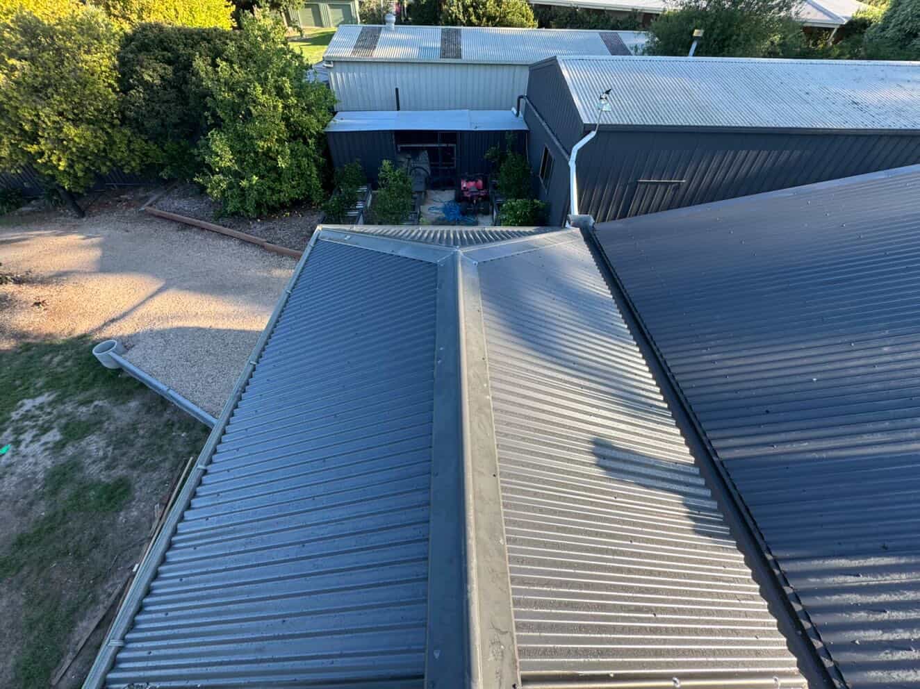 Professional roof inspection on a metal corrugated roof
